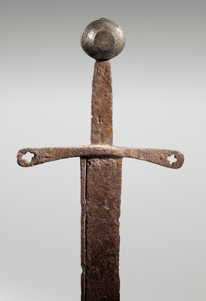 The hilt and pommel of the Thorpe Falchion, with mythical monsters carved into the hilt
